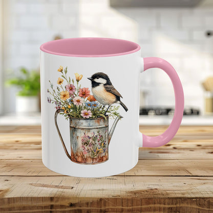 White 11oz ceramic mug with pink handle and interior, featuring a chickadee on a floral watering can.