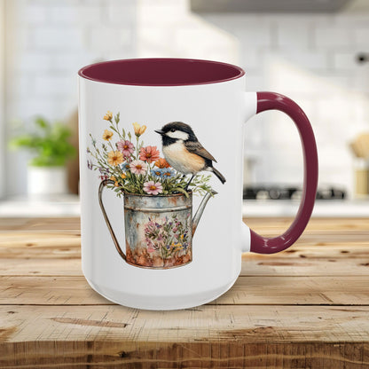 15oz ceramic mug with a maroon interior and handle, featuring a watercolor chickadee on a floral watering can.