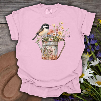 Blossom pink S-size t-shirt with a chickadee perched on a floral watering can design.