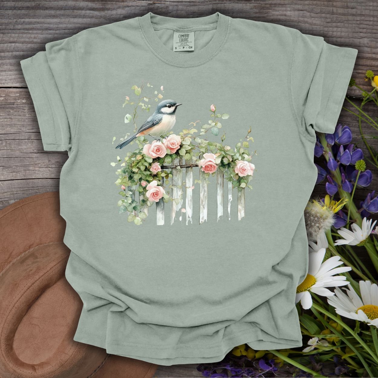 Bay garment-dyed cotton t-shirt with a watercolor chickadee on a rose-covered fence.