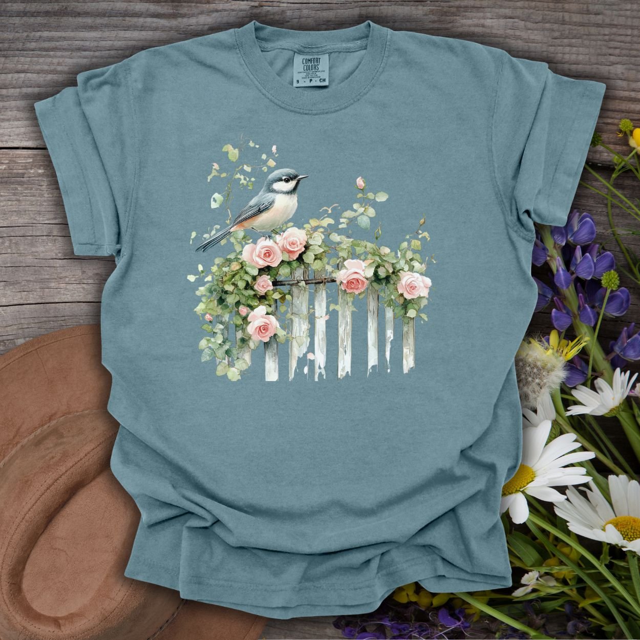 Ice Blue S t-shirt with a watercolor chickadee on a rose-covered picket fence.
