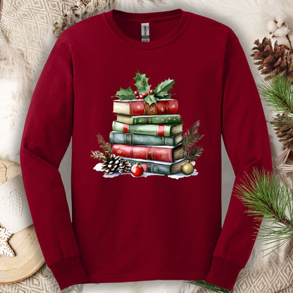 Cardinal Red long sleeve tee with a vintage watercolor Christmas book stack, holly, pinecones, and ornaments.