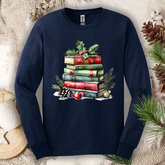 Navy long sleeve tee with a vintage watercolor Christmas book stack, holly, pinecones, and ornaments.