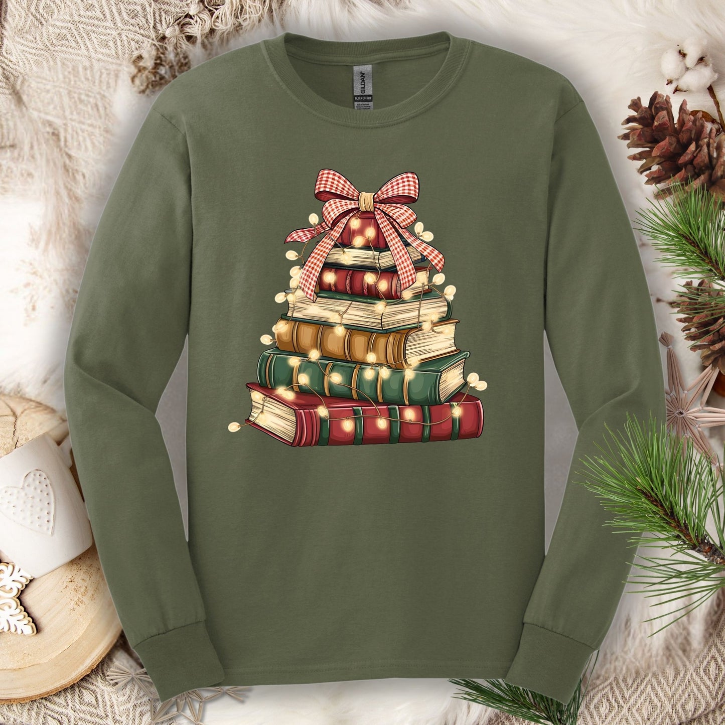 Military Green long sleeve tee with a watercolor Christmas book tree design and string lights.