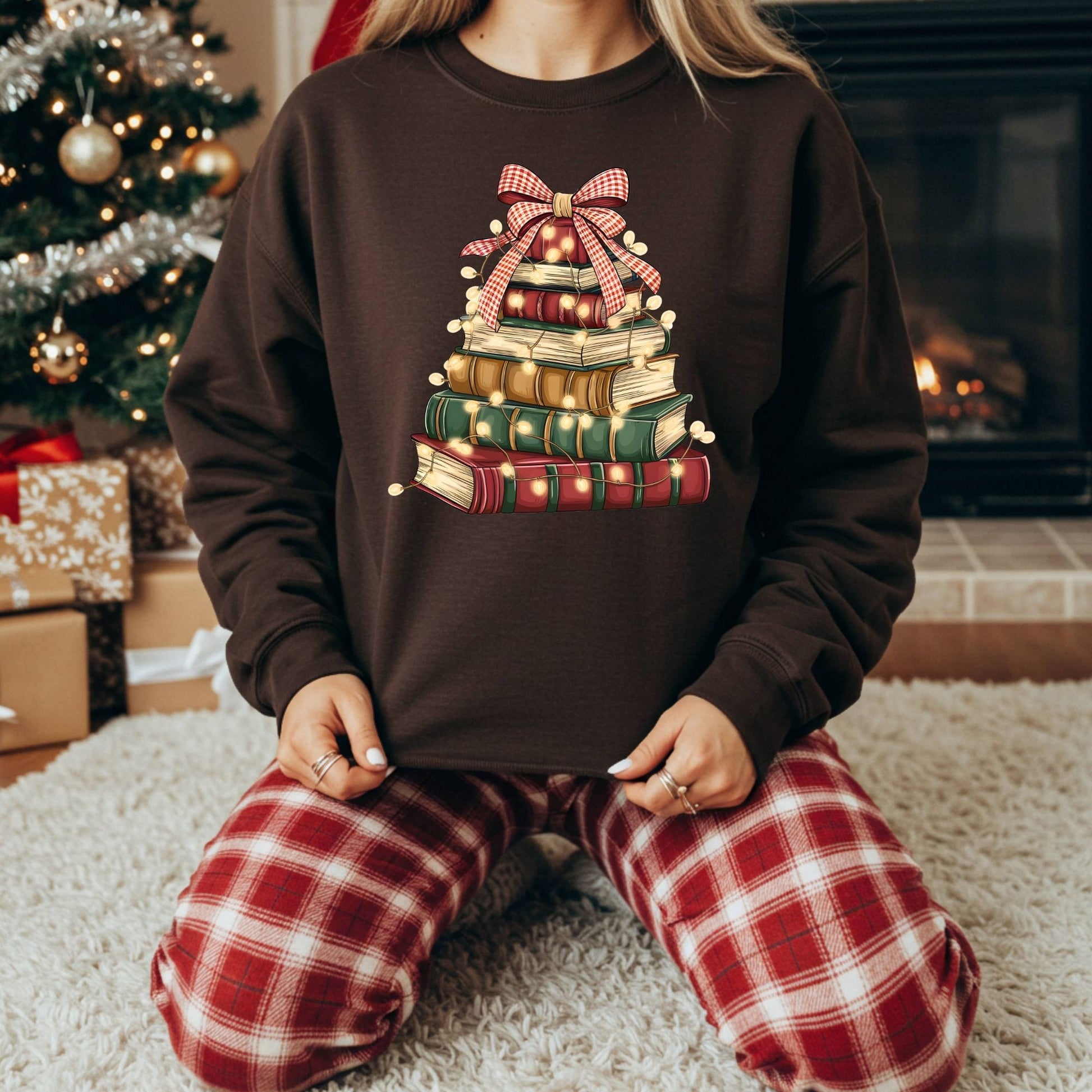 Brown fleece sweatshirt with a vintage book Christmas tree design and glowing lights.