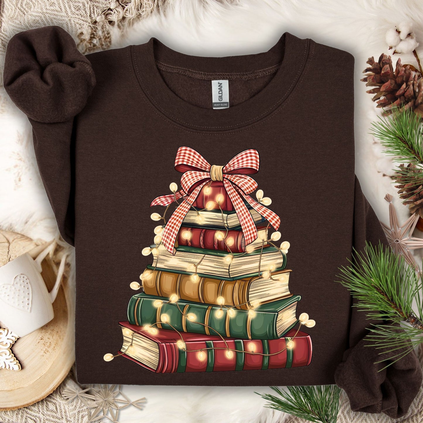 Dark chocolate sweatshirt with a vintage book Christmas tree design, glowing lights, and a plaid bow.