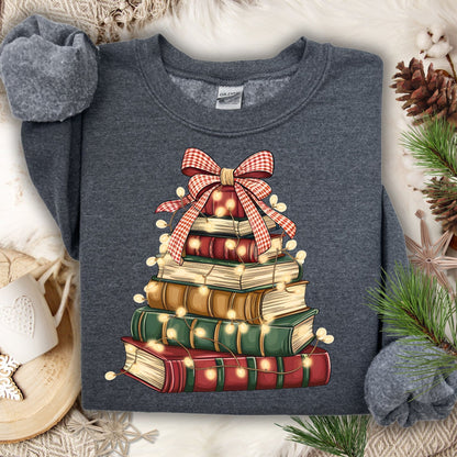 Dark Heather sweatshirt with a vintage book stack Christmas tree design, glowing lights, and a plaid bow.