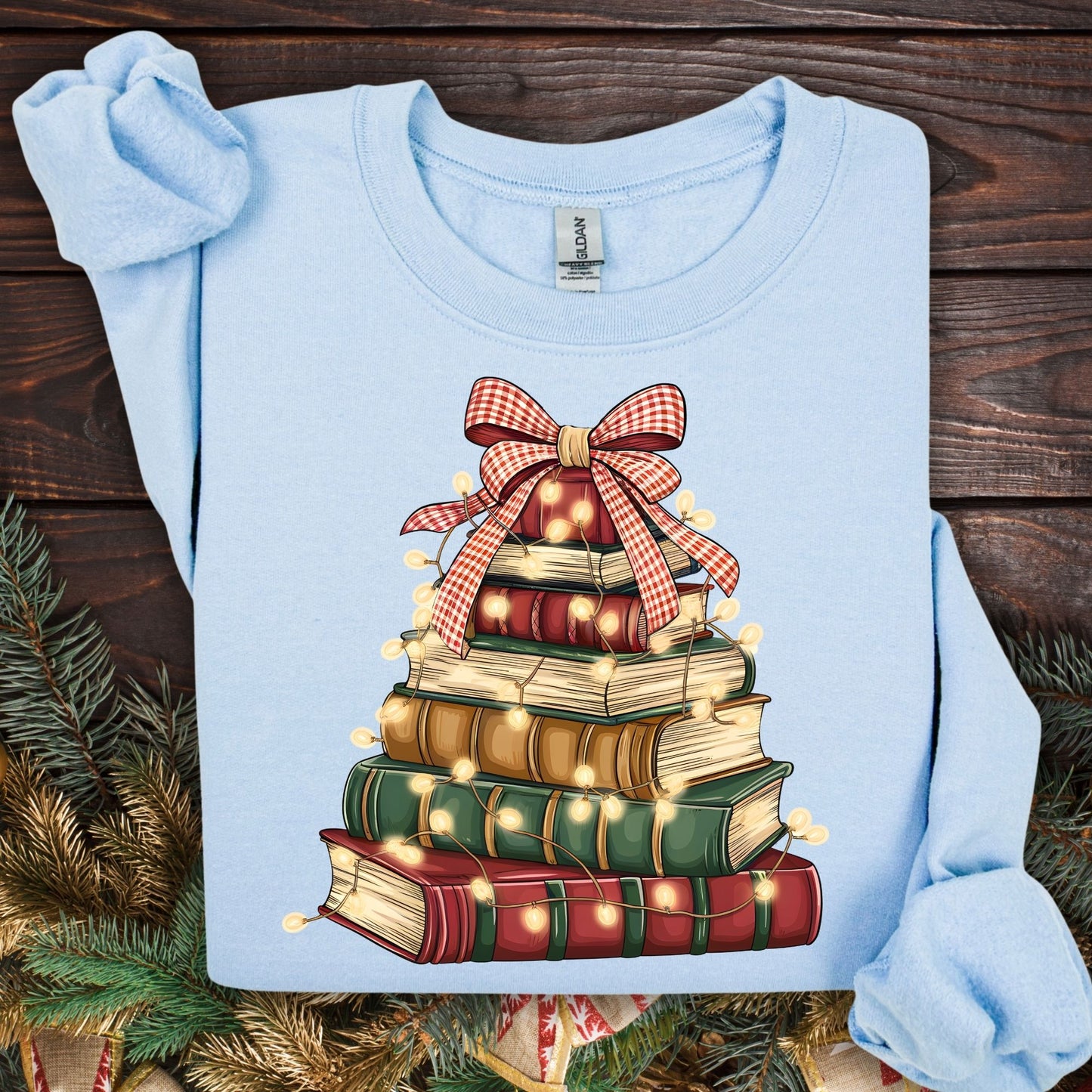Light blue Gildan sweatshirt with a vintage watercolor book tree design, festive lights, and a plaid bow.