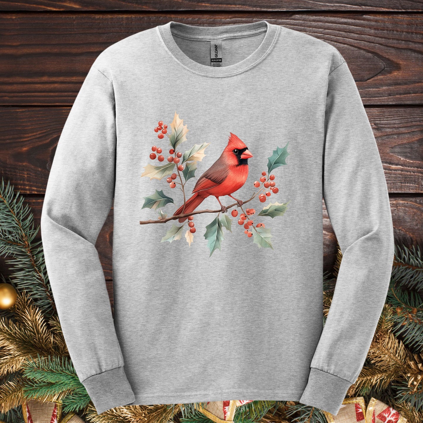 Ash gray Gildan long sleeve tee with a watercolor red cardinal on a holly branch.