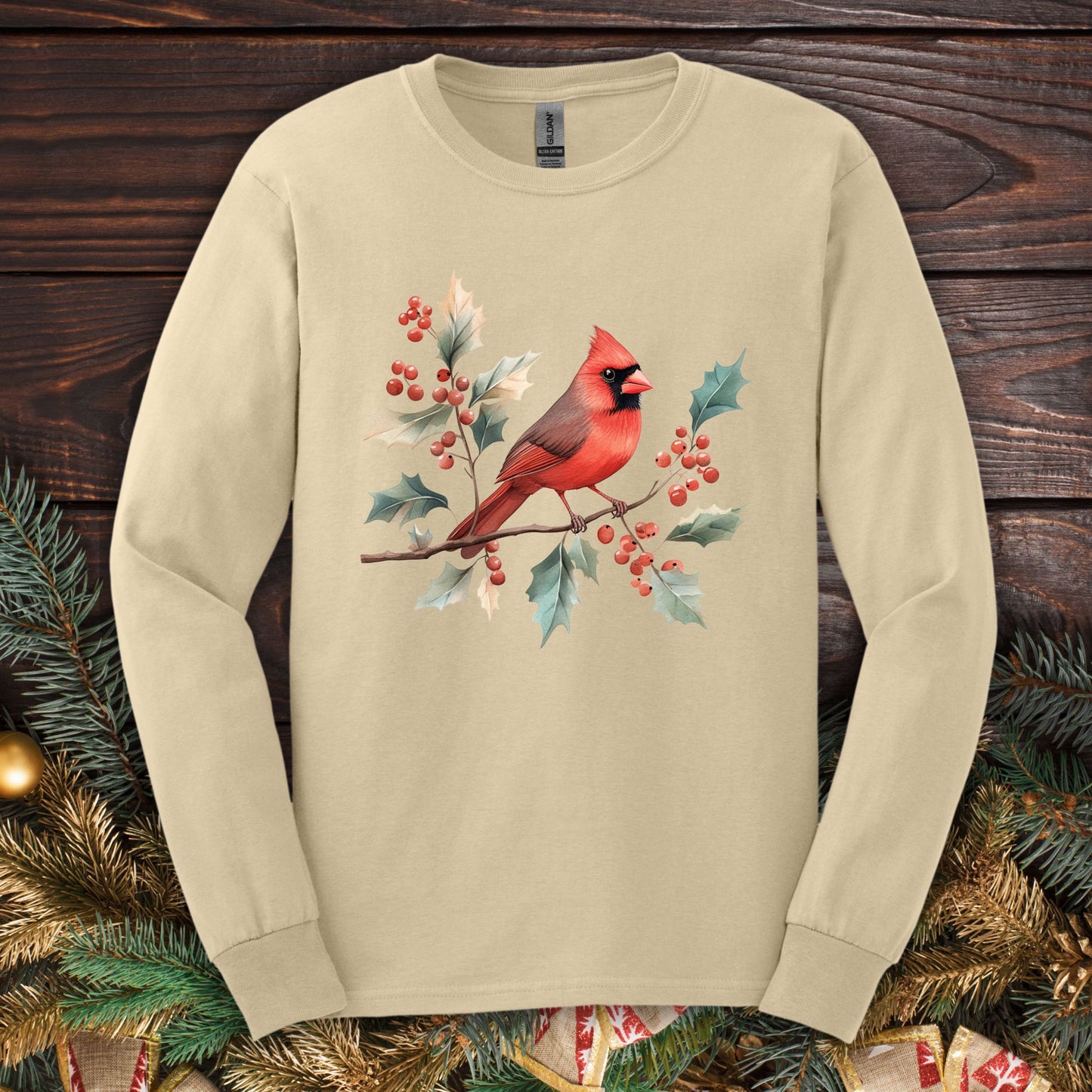 Sand long sleeve tee with a watercolor red cardinal on a holly branch design.