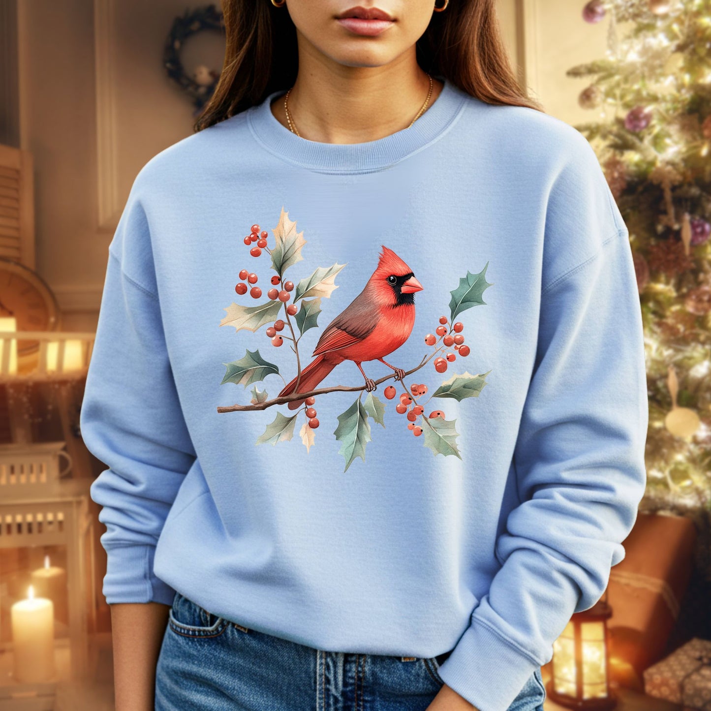 Light blue crewneck sweatshirt with a vibrant red cardinal on holly branches.