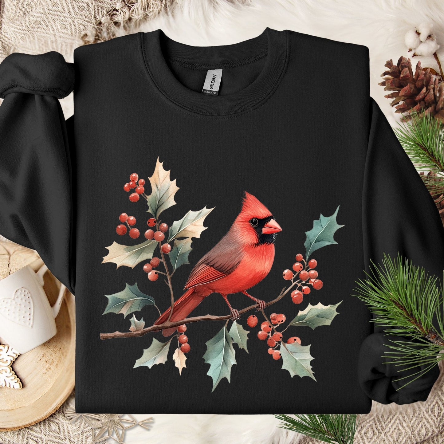 Black crewneck sweatshirt with a vibrant red cardinal on holly branches and berries.