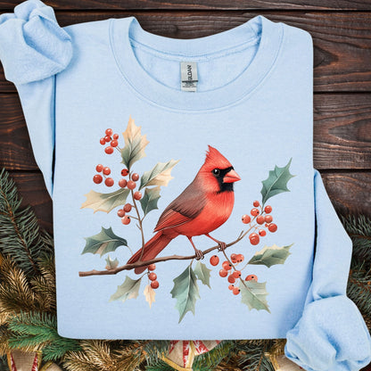 Light blue unisex sweatshirt with a vibrant red cardinal perched on holly branches with berries.