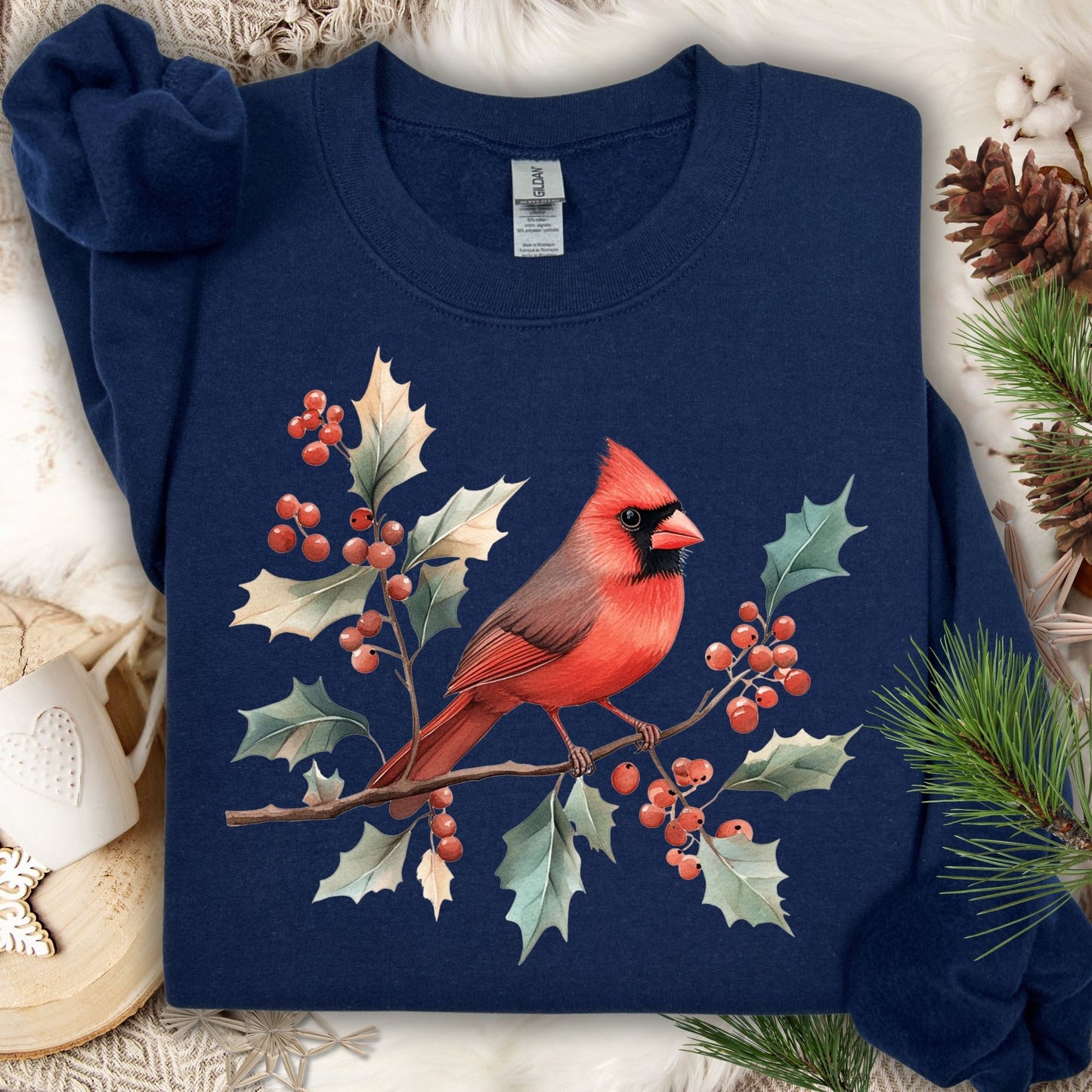 Navy crewneck sweatshirt with a vibrant red cardinal on holly branches.