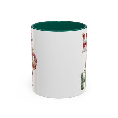 White ceramic Christmas mug with green interior and "Ho Ho Ho" in plaid, candy-cane, and woodland textures.