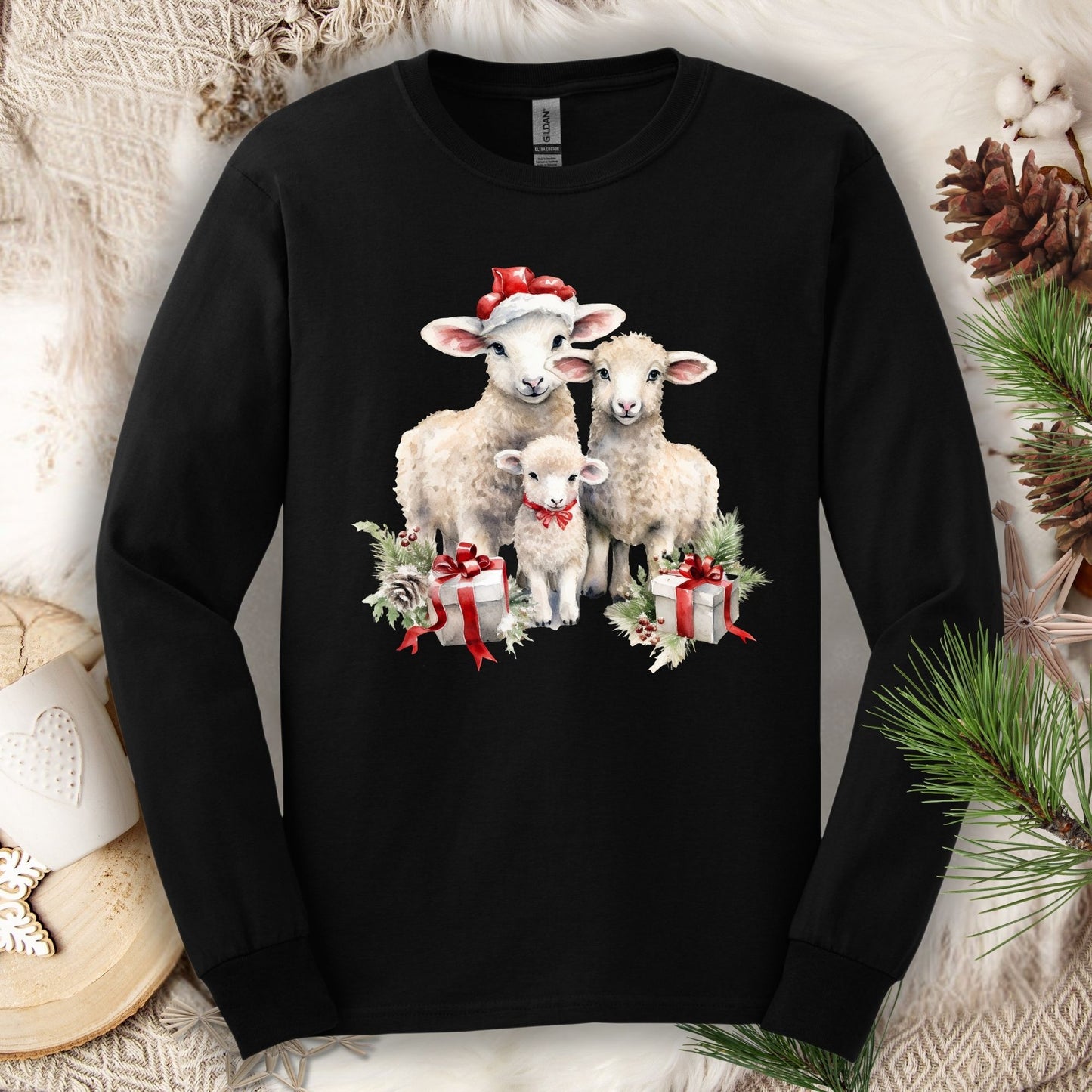 Black Gildan long sleeve tee with watercolor Christmas lambs in Santa hats and gifts.