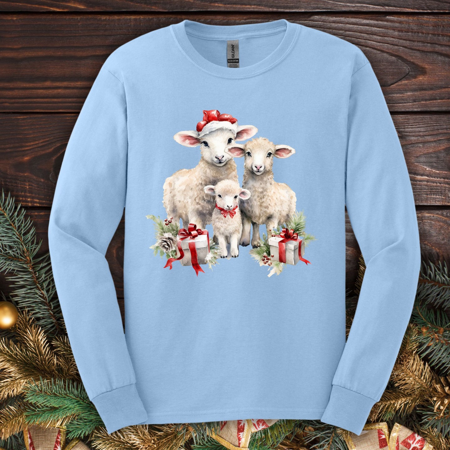 Light blue Gildan long sleeve tee with watercolor Christmas lambs in Santa hats and gifts.
