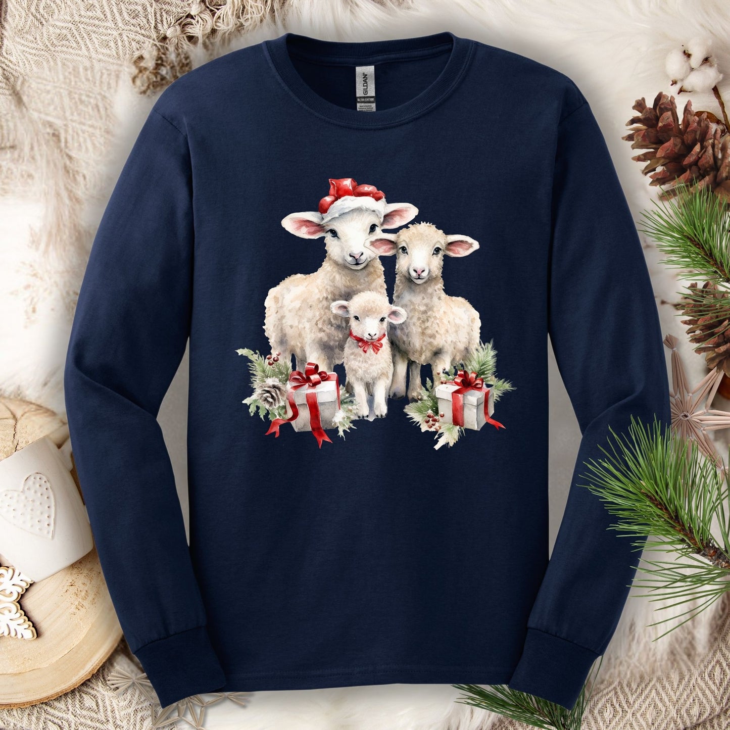 Navy Gildan long sleeve tee with watercolor Christmas lambs in Santa hats and gifts.
