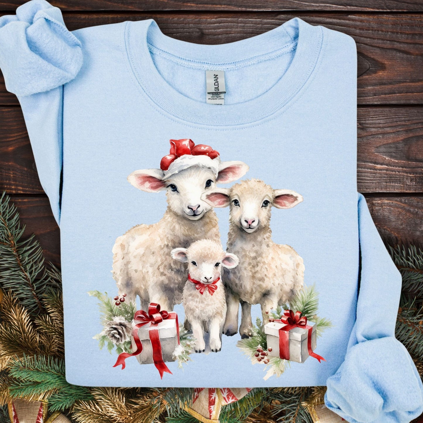 Light blue Gildan crewneck sweatshirt with three watercolor lambs in Santa hats and gifts.