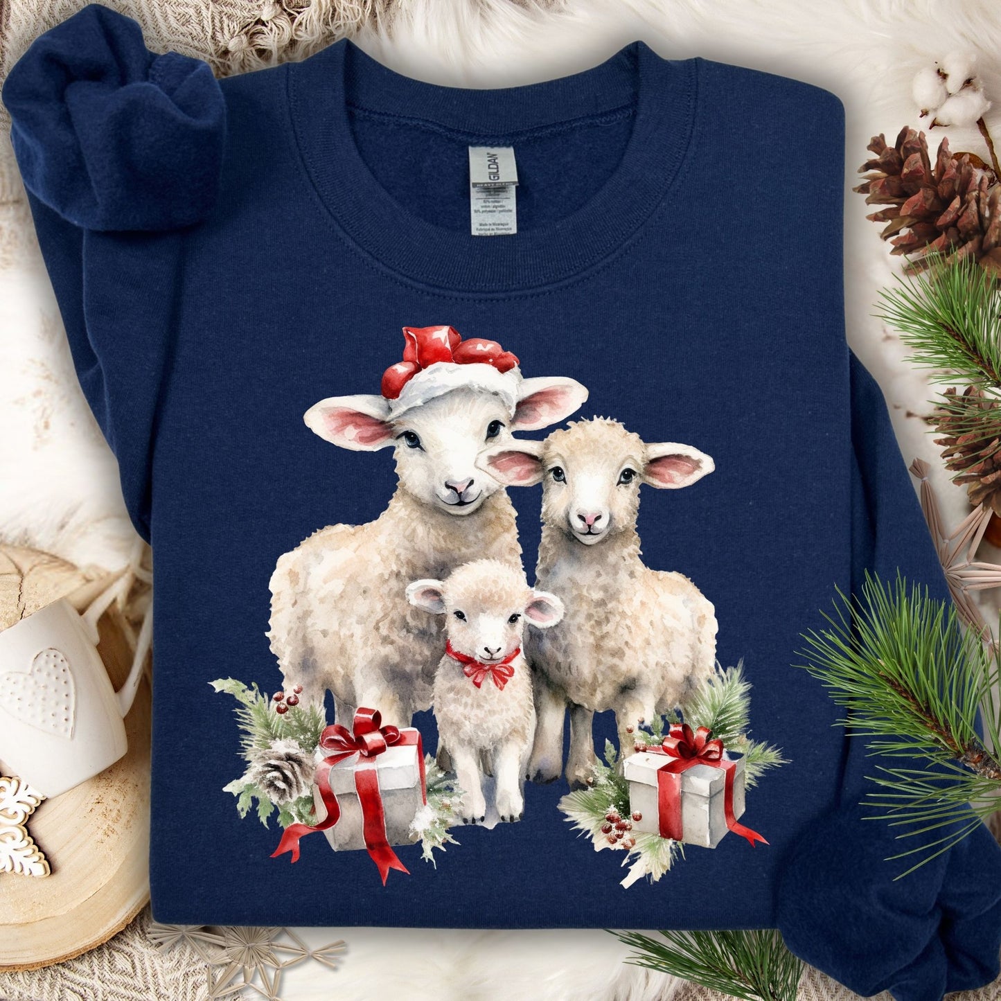 Navy crewneck sweatshirt with three watercolor lambs in Santa hats and gifts.