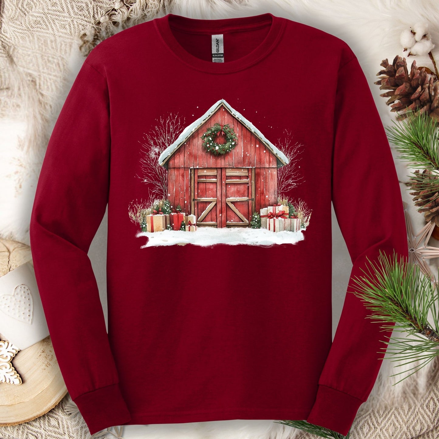 Cardinal Red Gildan Softstyle long sleeve tee with watercolor red barn, snow, gifts, and wreath.