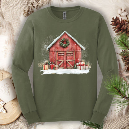 Military green long sleeve tee with a watercolor red barn, snow, gifts, and wreath.