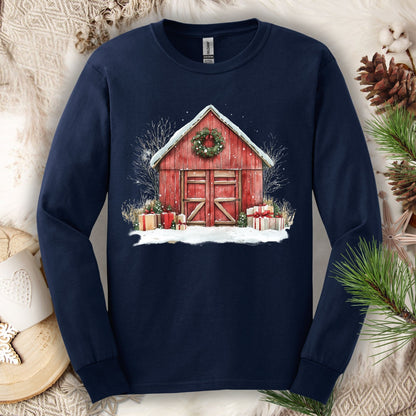 Navy long sleeve tee with a watercolor red barn, snow, gifts, and a Christmas wreath design.