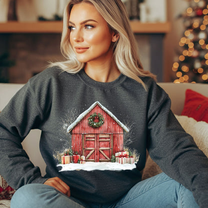 Blonde woman wearing a charcoal gray Gildan fleece sweatshirt with a vintage watercolor red barn, snow, and gifts.