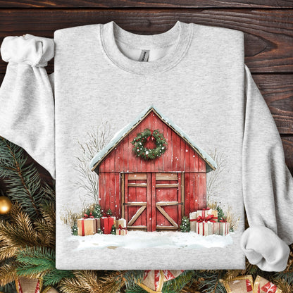 Ash Gildan S sweatshirt with a watercolor red barn, snow, wreath, and Christmas gifts.