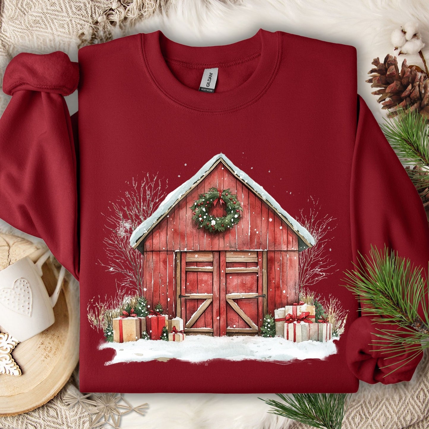 Cardinal Red Gildan fleece sweatshirt with a watercolor red barn, snow, wreath, and gifts.