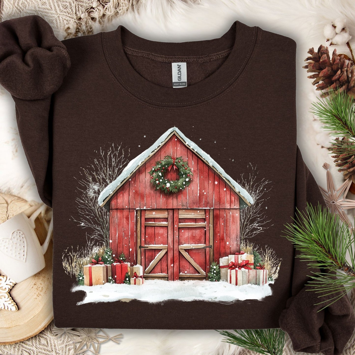 Dark Chocolate Gildan sweatshirt with a watercolor red barn, snow, wreath, and Christmas gifts.