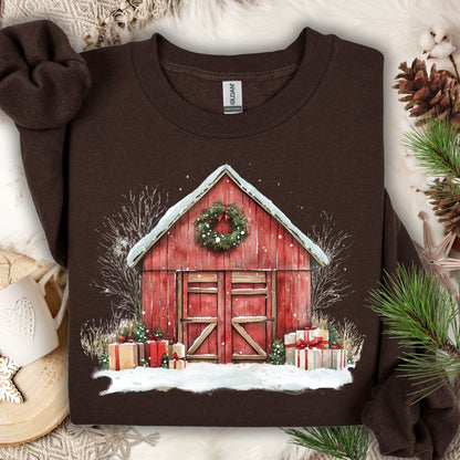 Dark Chocolate Gildan sweatshirt with a watercolor red barn, snow, wreath, and Christmas gifts.
