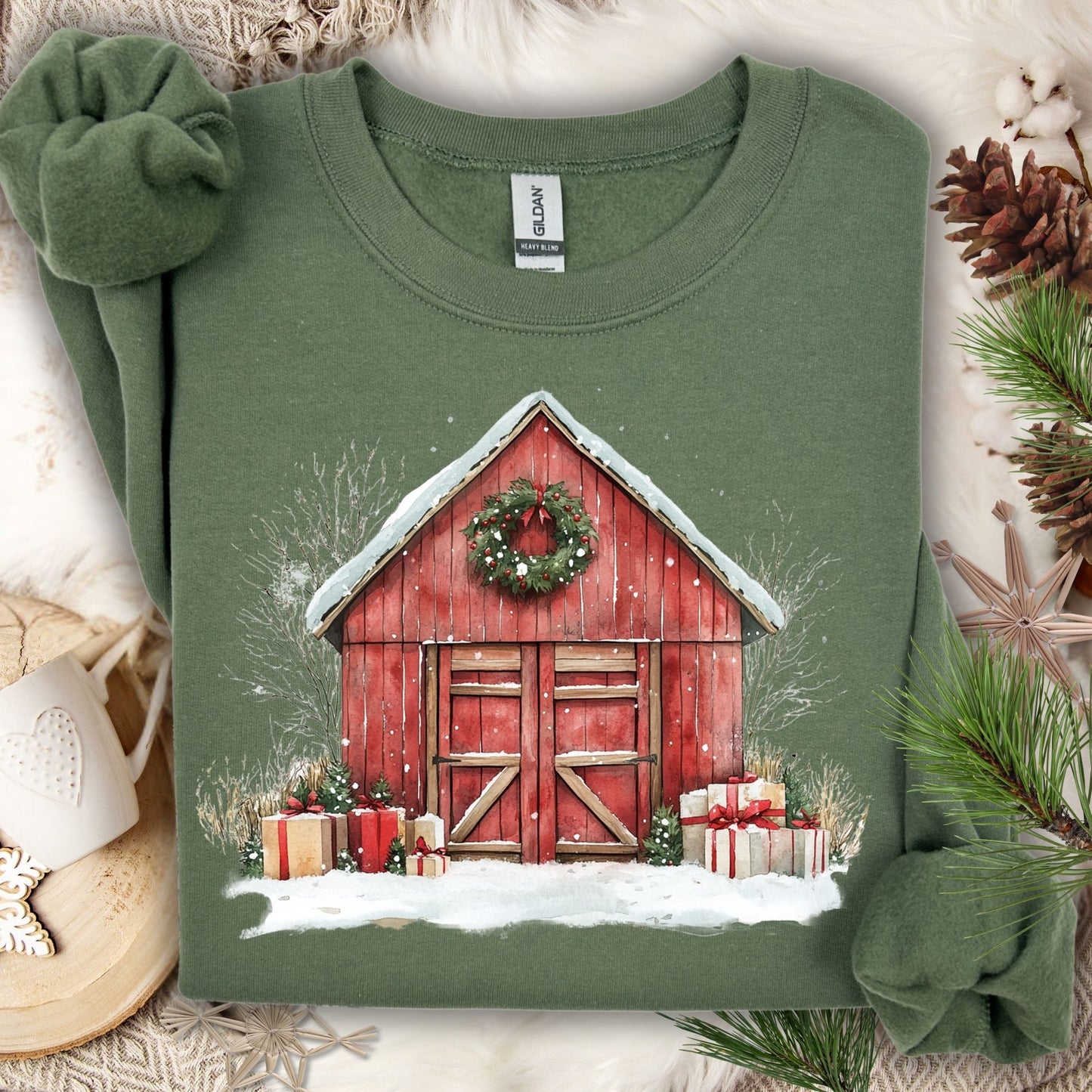 Military Green Gildan sweatshirt with a watercolor red barn, snow, wreath, and gifts.