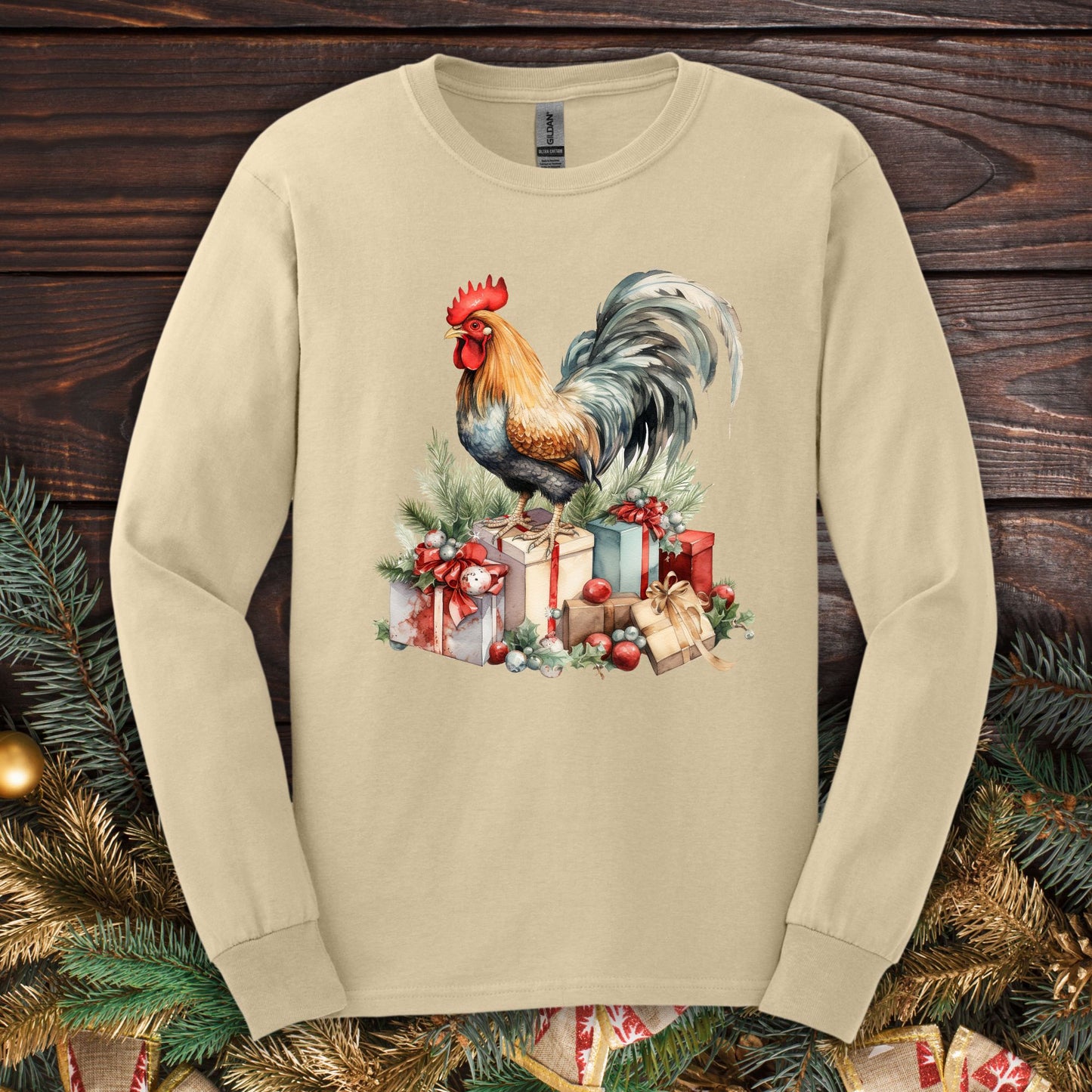 Sand Gildan long sleeve tee with a watercolor Christmas rooster on presents.