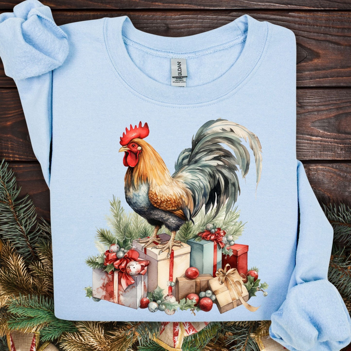 Light blue Gildan Christmas Rooster Sweatshirt, size S, with a watercolor rooster on festive gifts and pine.