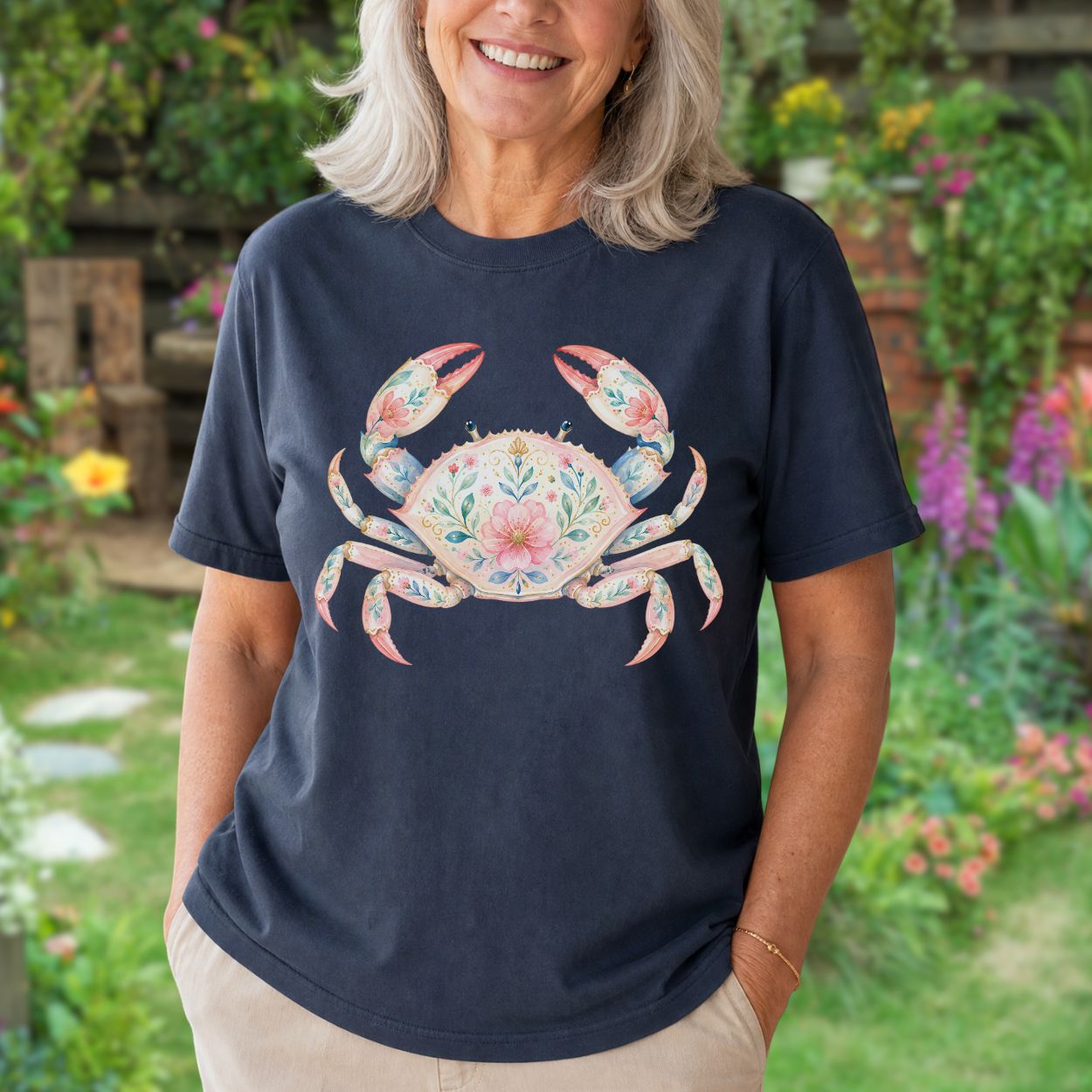 Woman in a relaxed-fit, garment-dyed navy t-shirt featuring a watercolor floral crab design.