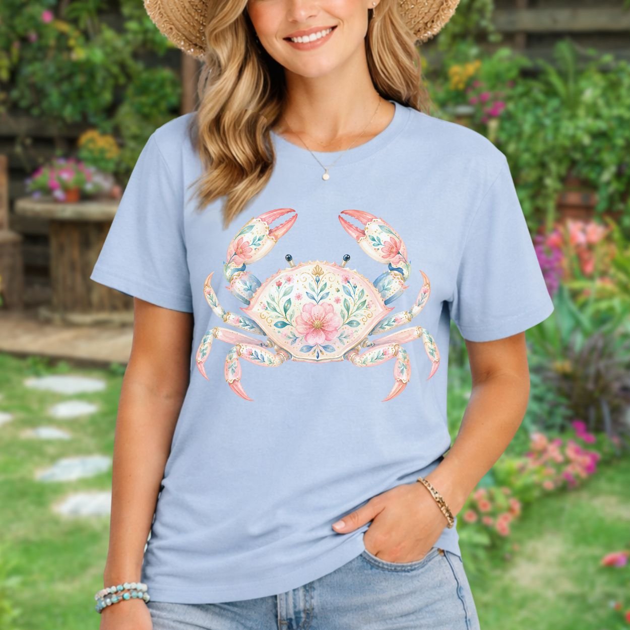 Woman in a light blue garment-dyed t-shirt featuring a watercolor floral crab design.