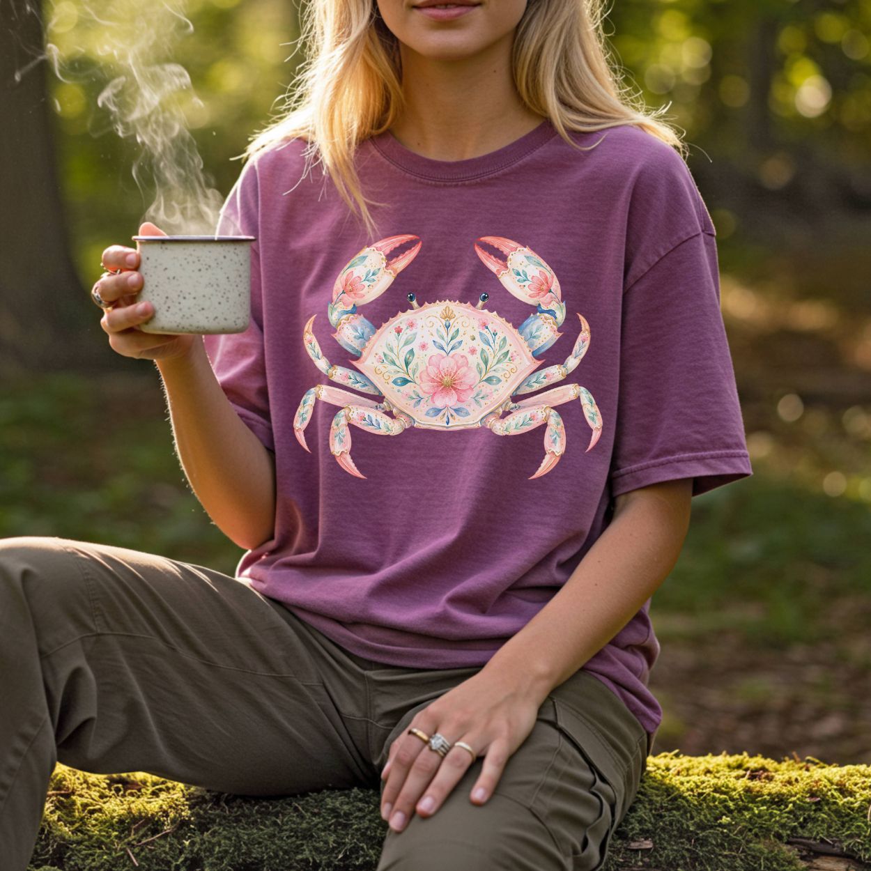 Woman wearing a relaxed-fit, garment-dyed plum t-shirt with a watercolor floral crab design.