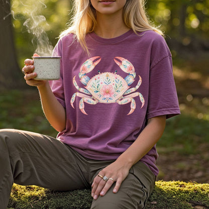 Woman wearing a relaxed-fit, garment-dyed plum t-shirt with a watercolor floral crab design.