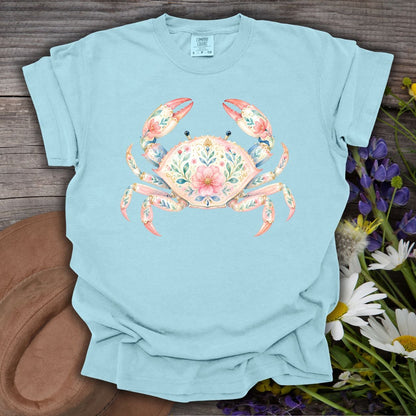 Chambray blue garment-dyed t-shirt with a watercolor floral crab design on wood.