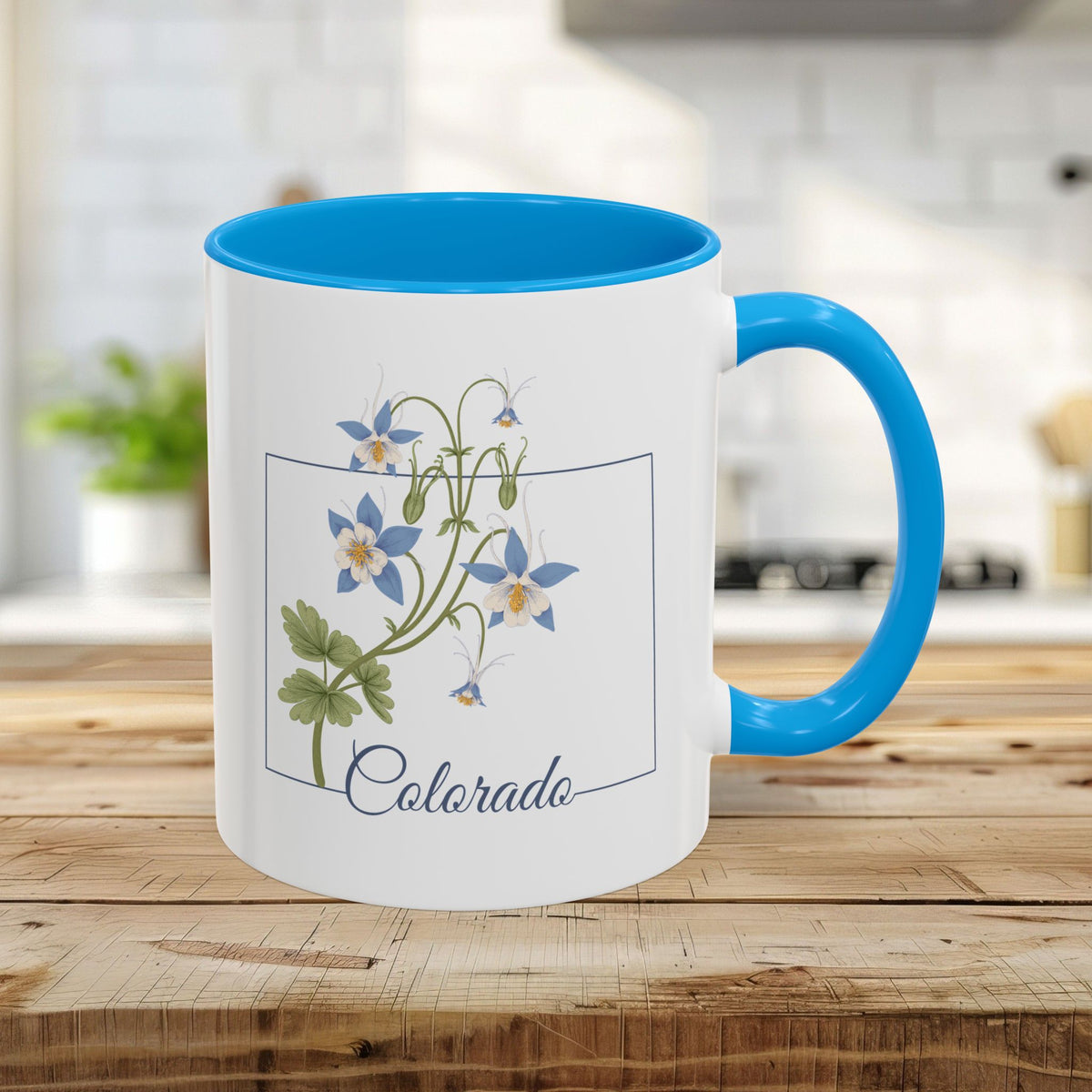 White 11oz ceramic mug with light blue interior/handle, featuring Colorado Rocky Mountain Columbine art.