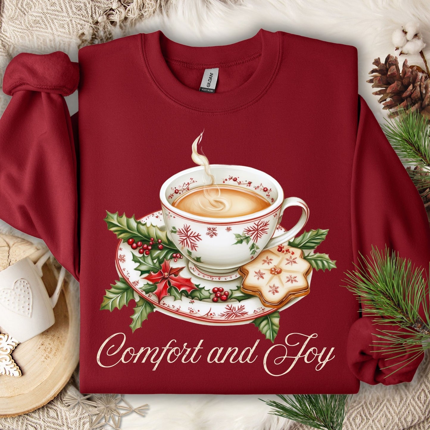 Cardinal Red long-sleeve cotton sweatshirt with watercolor Christmas teapot, holly, cookie, and "Comfort and Joy" text.