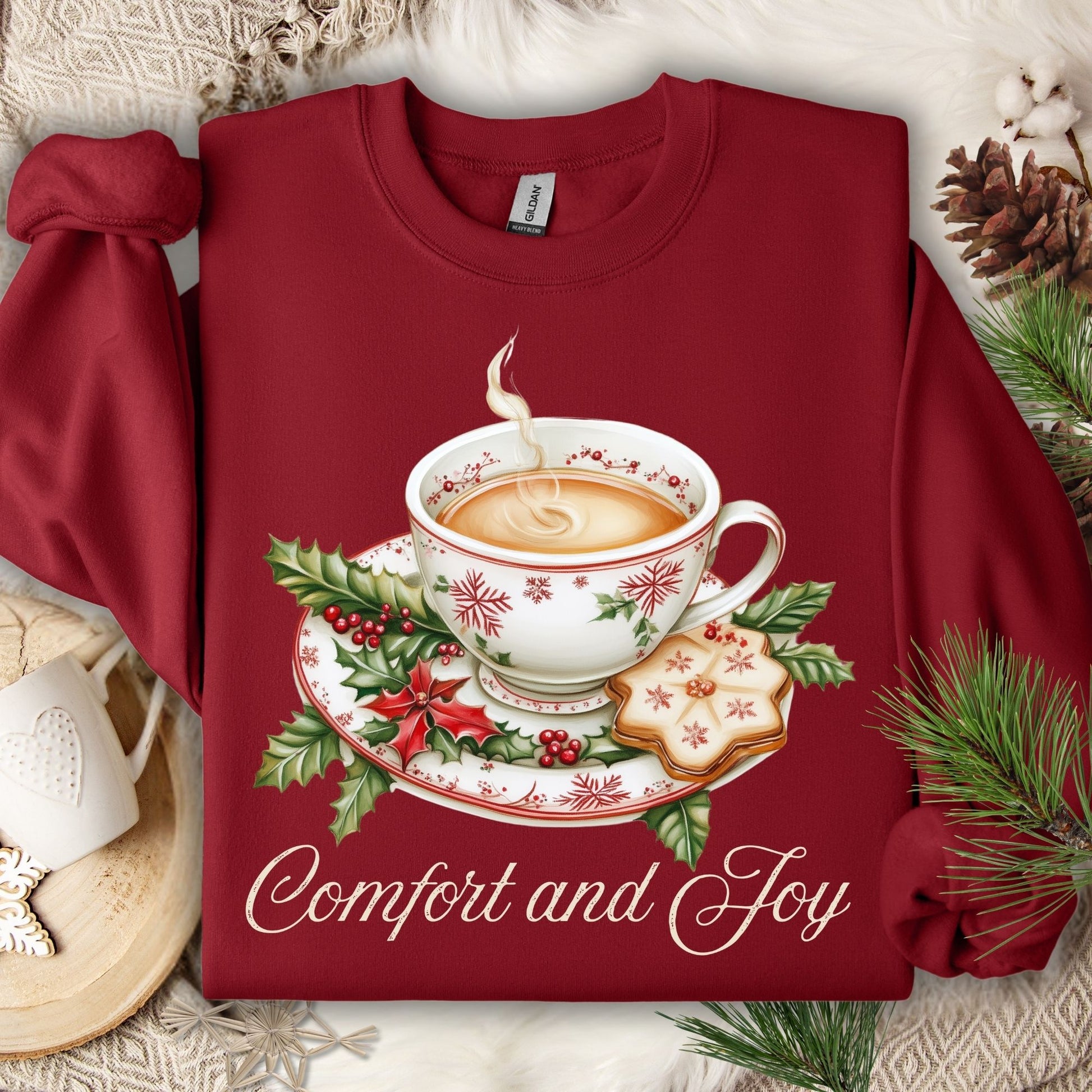 Cardinal Red long-sleeve cotton sweatshirt with watercolor Christmas teapot, holly, cookie, and "Comfort and Joy" text.