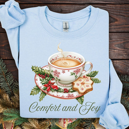 Light blue long-sleeve sweatshirt with a watercolor Christmas teapot, holly, and "Comfort and Joy" text.