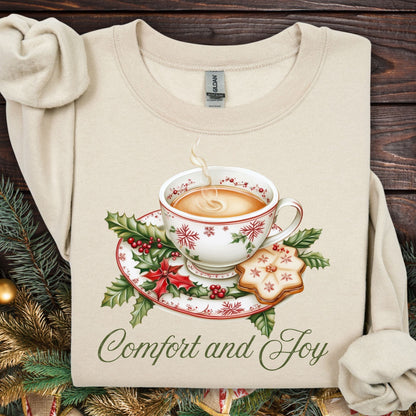 Sand S sweatshirt with watercolor Christmas teapot, holly, cookie, and "Comfort and Joy" text.