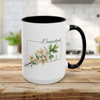 15oz white ceramic mug with black interior/handle, featuring a watercolor Mountain Laurel over a Connecticut outline.