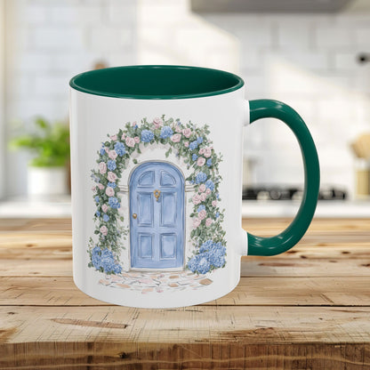 11oz ceramic mug with green interior/handle and a watercolor blue cottage door with pink roses and blue hydrangeas.