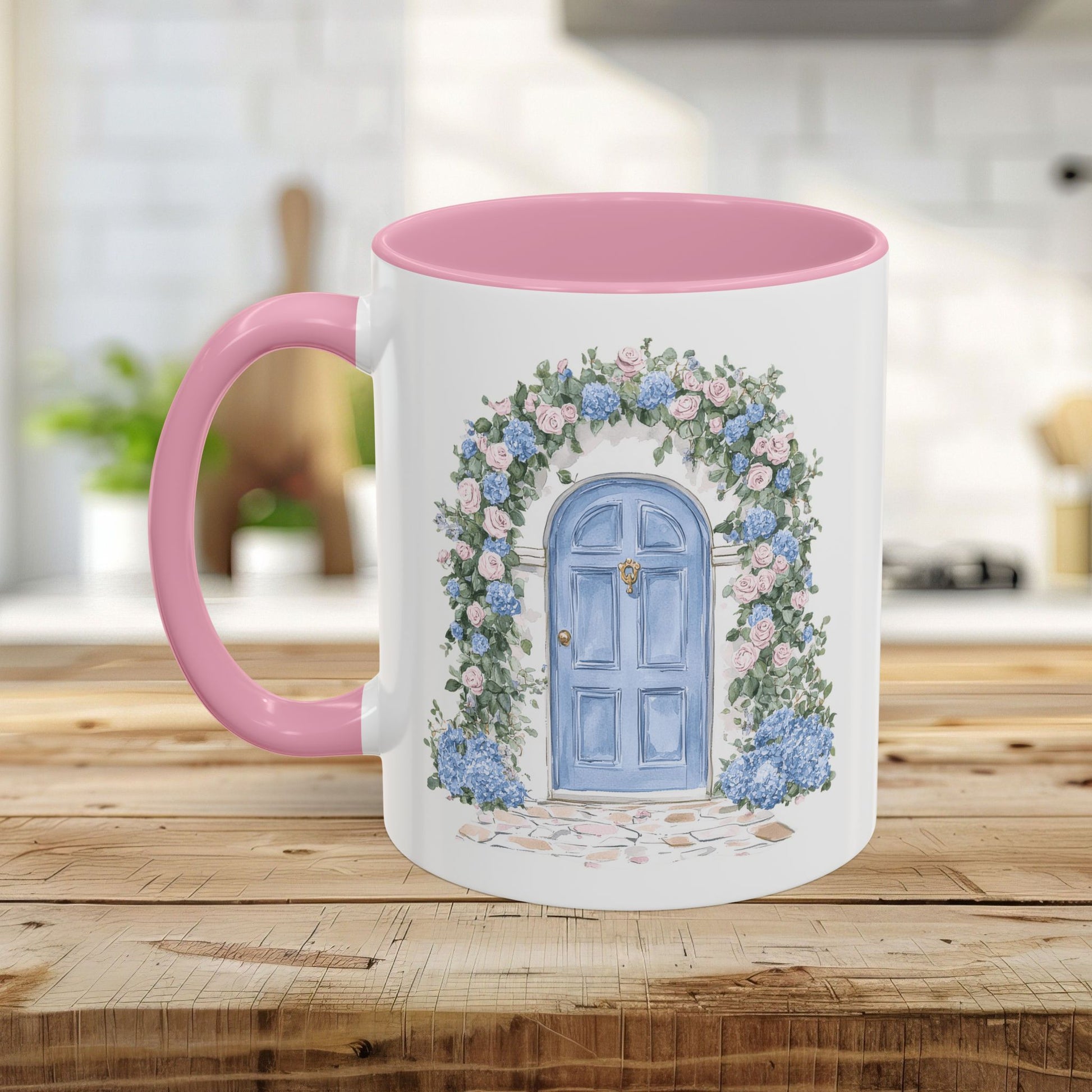 White ceramic mug with pink interior and handle, featuring a watercolor blue doorway framed by pink roses and blue hydrangeas.