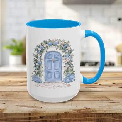 15oz ceramic mug with a light blue interior and handle, featuring a hand-painted blue door with climbing roses and hydrangeas.