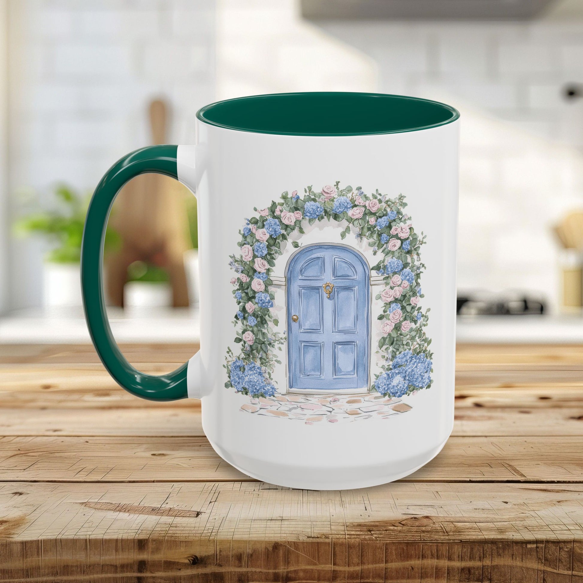 White ceramic 15oz mug with green handle/interior, featuring a hand-painted blue cottage door with pink and blue hydrangeas.